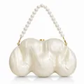 Macro view of shell texture acrylic clutch bag with pearl handle and gold clasp hardware - Milky White
