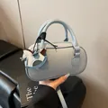 Light blue pebbled leather bowling bag with a horse charm and adjustable shoulder strap - With Pendant / Blue