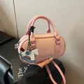 Pink lychee grain leather Boston handbag with a colorful rocking horse charm - With Pendant / Pink