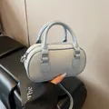 Light blue pebbled leather mini bowling bag with top handles and crossbody strap - No Pendant / Blue