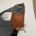 Bruine bucket bag met lychee korrel, dik handvat en zilveren kettingriem voor dames - Bruin