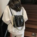 Chic black quilted bucket backpack with golden chain and drawstring closure - Small / Black