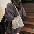 Silver quilted drawstring chain bucket bag with metallic finish and gold chain strap - Small / Silver