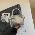 Chic silver metallic bucket bag with adjustable strap and designer logo detail - Silver No Pendant
