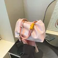 Pink pleated cloud crossbody bag with colorful braided handles and adjustable strap - Pink