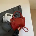 Glossy red patent leather bucket bag with silver metal logo and crossbody strap - Wine Red Without Pendant