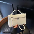 Chic cream white leather crossbody box bag with quilted diamond pattern and silver zippers - White