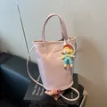 Minimalist light purple bucket bag with lychee texture and cute doll pendant decoration - Small / Lotus root pink