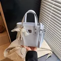 Light blue PU leather bucket handbag with elegant pearl lace bow charm and shoulder strap - Blue with Bowknot Heart Pendant