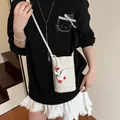 White lychee pattern leather mobile phone crossbody bag with cute duck pendant accessory - Off-White With Charm