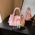 Pink lychee grain handbag with pearl doll charm shown in creative mirror reflection - 21*11*15 / Pink With Pendant