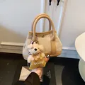 Beige woven tote bag with camel leather trim and cute teddy bear charm detail - Khaki (Small With Charm)