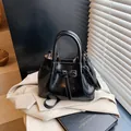 Chic black pleated bucket bag with shiny patent leather finish and top handles - 21*11*15 / Black without Pendant