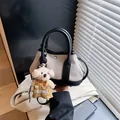 Mini canvas tote with black leather trim and cute teddy bear pendant held by hand - Black (Small With Charm)