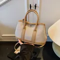 Canvas and khaki leather trapezoid tote bag with metallic buckle and round handles - Khaki (Large Without Charm)