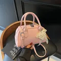 Pink lychee grain faux leather Boston bag with pearl heart charm and shoulder strap - Pink with Accessories
