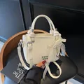 White mini bucket bag with lace bow, pearl charm, and lychee grain leather finish - Bow Charm Style / Off White