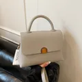 Light gray lychee pattern leather handbag with metal lock and single top handle - Gray