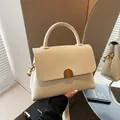 Elegant cream white lychee pattern leather handbag with gold buckle and shoulder strap - Beige