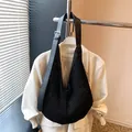 Chic black woven hollow tote bag with adjustable leather shoulder strap and silver buckle - Black
