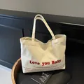 Cream canvas tote bag featuring red Love you Baby print and black inspirational quotes - Off White / Large
