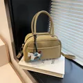 Khaki faux leather top handle barrel bag with detachable strap and horse charm - Green With Charm
