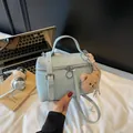 Light blue pleated leather handbag with bear charm and silver hardware accents - Blue (with Pendant)