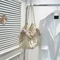 Chic cream straw tote bag with pink wavy edges and purple tulip charm detail - Pink With Pendant