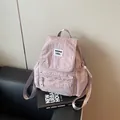 Dusty pink nylon backpack with minimalist front zipper pocket and side drawstring - Purple