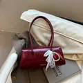 Retro dark red trendy crossbody bag with glossy faux leather and lace bow charm - With Pendant / Red