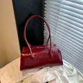 Burgundy cylindrical crossbody bag in glossy faux leather with a matching shoulder strap - No Pendant / Red