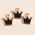 Detailed close-up of crown shaped gold alloy charms with black enamel filling for DIY crafts - Black