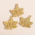 Detailed macro shot of yellow enamel maple leaf charms with gold metallic veins - Yellow