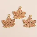 Three gold alloy maple leaf pendants with pink enamel and detailed leaf veins for DIY crafts - Pink