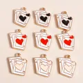 Macro view of poker card heart and spade pendants with gold-plated edges for DIY jewelry - Multicolor