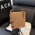 Brown hand-woven crossbody bag with hollow floral details and strawberry charms - Khaki With Strawberry Charm