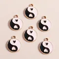 Detailed view of Chinese Yin Yang heart pendants with gold plating and enamel finish - Black Round Tai Chi