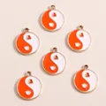 Detail of six orange and white heart yin-yang alloy drip oil charms with gold frames - Red Round Tai Chi