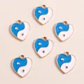Detailed view of heart-shaped Yin Yang enamel pendants with golden metal edges - Blue Heart Tai Chi