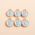 Close-up of circular light blue enamel letter E charms with golden alloy frame and loop - Letter E