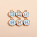 Detailed macro shot of light blue enamel letter H charms with gold metal plating - Letter H