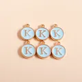 Close-up of light blue enamel letter K pendants with gold metal edge for DIY jewelry - Letter K