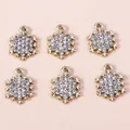 Macro detail of six sparkling silver snowflake charms with inlaid rhinestones for DIY - 10pcs/Pack / Gold