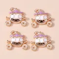 Detailed macro view of four gold-plated lavender enamel pumpkin carriage charms - Purple