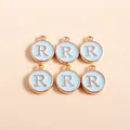 Close-up of circular light blue enamel letter R pendants with gold plating for DIY crafts - Letter R