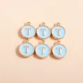 Close-up of six light blue enamel alphabet T charms with gold plated round alloy edges - Letter T