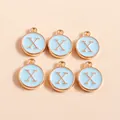 Detailed macro view of gold-plated enamel letter X charms for DIY jewelry making - Letter X