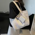 Beige large capacity woven tote bag with matching pouch shown on shoulder - 46*15*29 / Off White