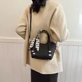 Chic black bucket bag with houndstooth silk scarf handle and leather crossbody strap - Black