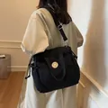 Versatile black nylon crossbody tote bag with bear logo and adjustable strap - Black